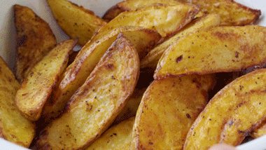 Tossing potato wedges with seasoning